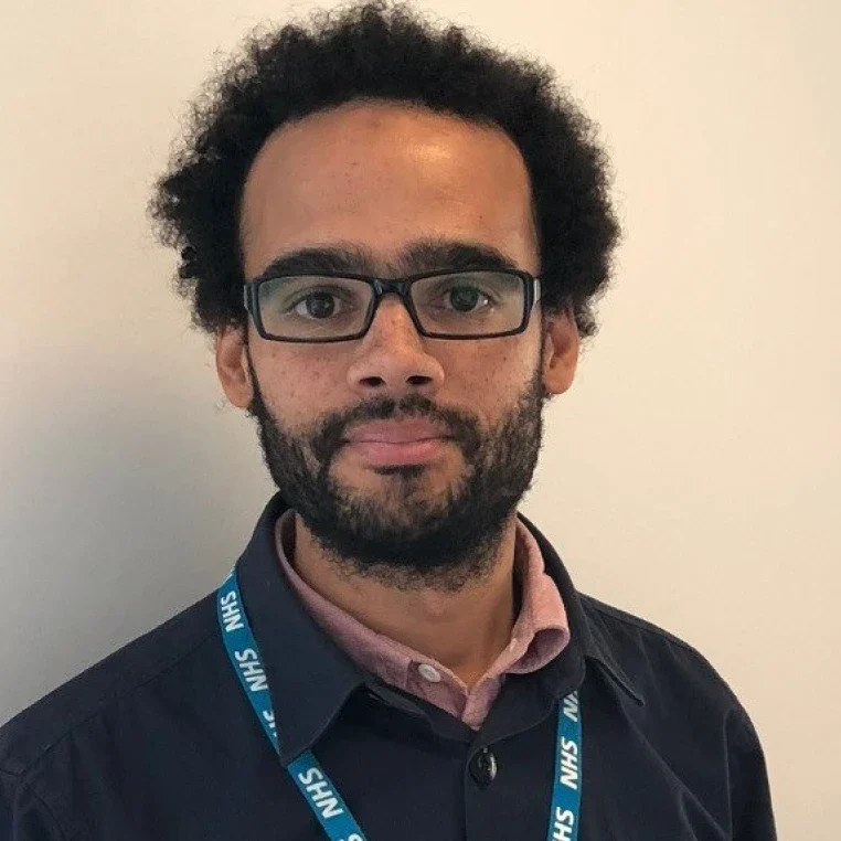 Man wearing glasses and lanyard